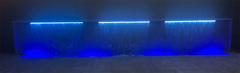 Purple LED lights on custom water feature built by Willsha Pools