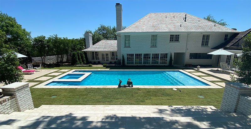 Completed Pool Remodel project with landscaping and grand staircase